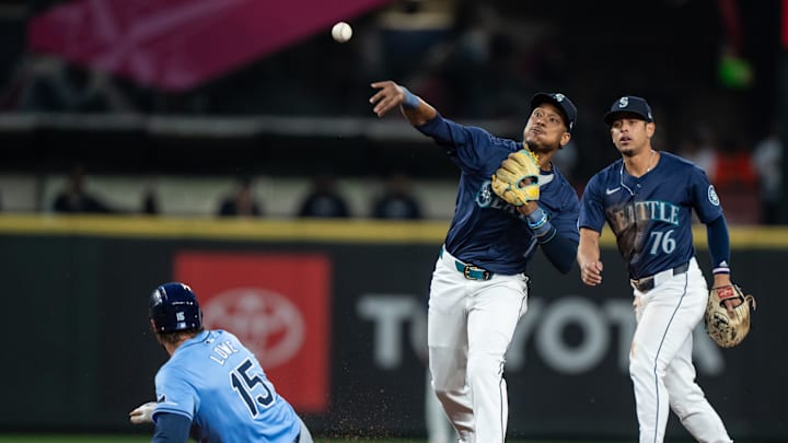 Seattle Mariners second baseman Jorge Polanco (7) attempts to turn a double play after forcing out right fielder Josh Lowe (15) at second base as Seattle Mariners shortstop Leo Rivas (76) watches during the fifth inning at T-Mobile Park on Aug 26. Seattle Mariners second baseman Jorge Polanco (7) attempts to turn a double play after forcing out right fielder Josh Lowe (15) at second base as Seattle Mariners shortstop Leo Rivas (76) watches during the fifth inning at T-Mobile Park on Aug 26.