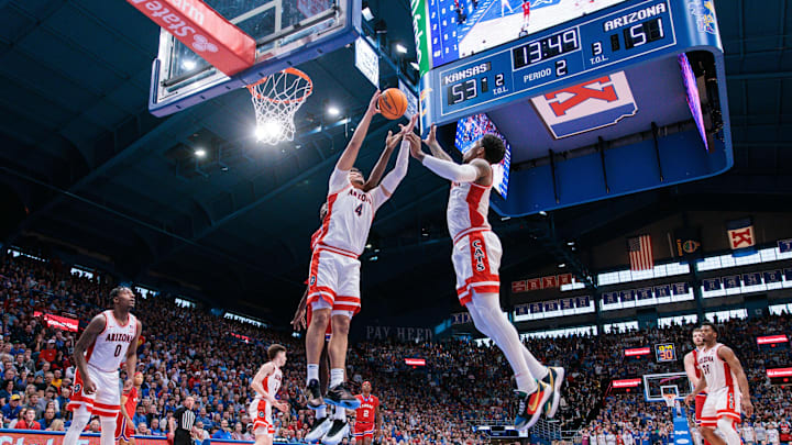 Mar 8, 2025; Lawrence, Kansas, USA; Arizona Wildcats forward Trey Townsend (4) rebounds during the second half against the Kansas Jayhawks at Allen Fieldhouse. Mandatory Credit: William Purnell-Imagn Images