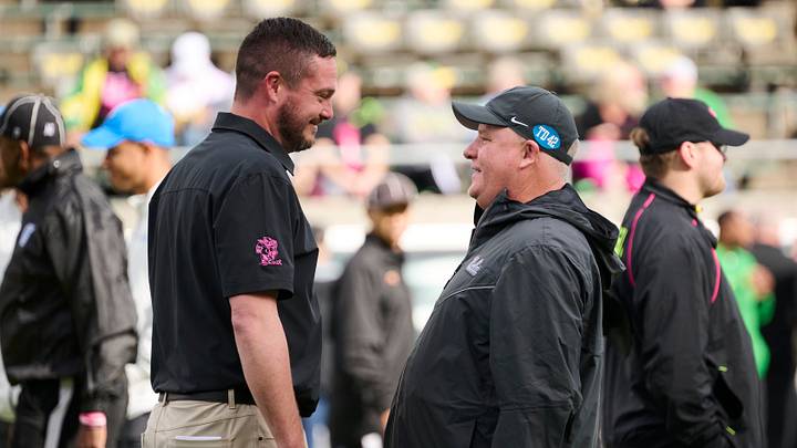 Oct 22, 2022; Eugene, Oregon, USA; Oregon Ducks head coach Dan Lanning, left, visits with UCLA Bruins head coach Chip Kelly before a game at Autzen Stadium. Mandatory Credit: Troy Wayrynen-USA TODAY Sports