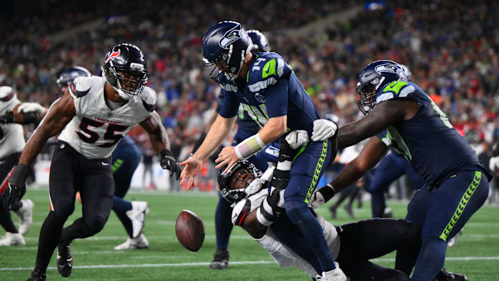 Oct 20, 2025; Seattle, Washington, USA; Houston Texans defensive end Will Anderson Jr. (51) forces a fumble from Seattle Seahawks quarterback Sam Darnold (14) in the end zone during the third quarter at Lumen Field. Mandatory Credit: Steven Bisig-Imagn Images