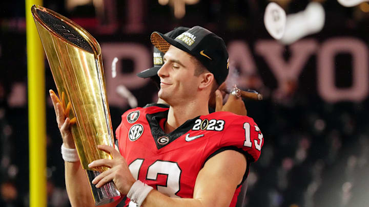 Jan 9, 2023; Inglewood, CA, USA; Georgia Bulldogs quarterback Stetson Bennett (13) holds the trophy after winning the CFP national championship game against the TCU Horned Frogs at SoFi Stadium. Mandatory Credit: Kirby Lee-Imagn Images Jan 9, 2023; Inglewood, CA, USA; Georgia Bulldogs quarterback Stetson Bennett (13) holds the trophy after winning the CFP national championship game against the TCU Horned Frogs at SoFi Stadium. Mandatory Credit: Kirby Lee-Imagn Images