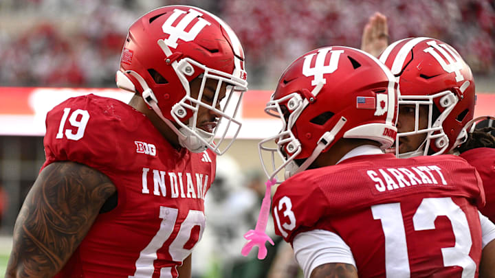 Oct 18, 2025; Bloomington, Indiana, USA; Indiana Hoosiers tight end Holden Staes (19) and wide receiver Elijah Sarratt (13) celebrate after a touchdown during the second half against the Michigan State Spartans at Memorial Stadium. Mandatory Credit: Robert Goddin-Imagn Images