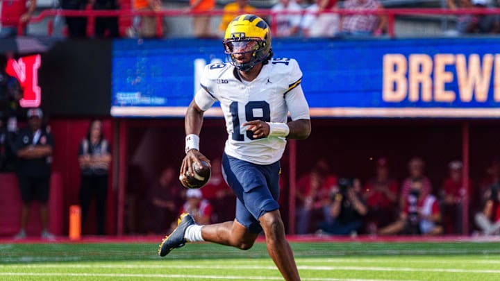 Sep 20, 2025; Lincoln, Nebraska, USA; Michigan Wolverines quarterback Bryce Underwood (19) scrambles against the Nebraska Cornhuskers during the third quarter at Memorial Stadium. Mandatory Credit: Dylan Widger-Imagn Images