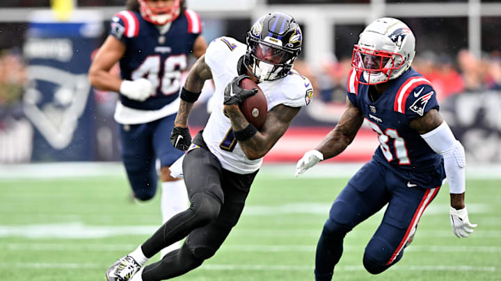 Sep 25, 2022; Foxborough, Massachusetts, USA; Baltimore Ravens wide receiver Rashod Bateman (7) runs with the ball in front of New England Patriots cornerback Jonathan Jones (31) during the second half at Gillette Stadium. Mandatory Credit: Brian Fluharty-Imagn Images
