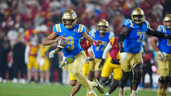 Nov 29, 2025; Los Angeles, California, USA; UCLA Bruins quarterback Nico Iamaleava (9) carries the ball against the Southern California Trojans in the first half at United Airlines Field at Los Angeles Memorial Coliseum. Mandatory Credit: Kirby Lee-Imagn Images
