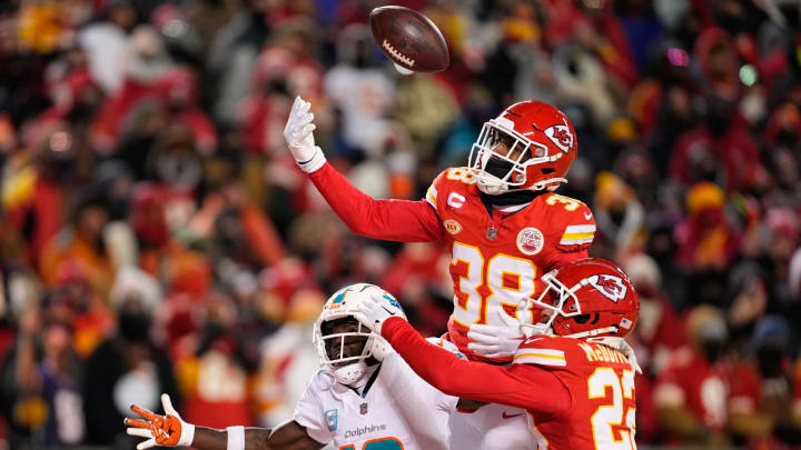 Jan 13, 2024; Kansas City, Missouri, USA; Kansas City Chiefs cornerback L'Jarius Sneed (38) and cornerback Trent McDuffie (22) break up a pass intended for Miami Dolphins wide receiver Tyreek Hill (10) during the second half of the 2024 AFC wild card game at GEHA Field at Arrowhead Stadium. Mandatory Credit: Jay Biggerstaff-USA TODAY Sports