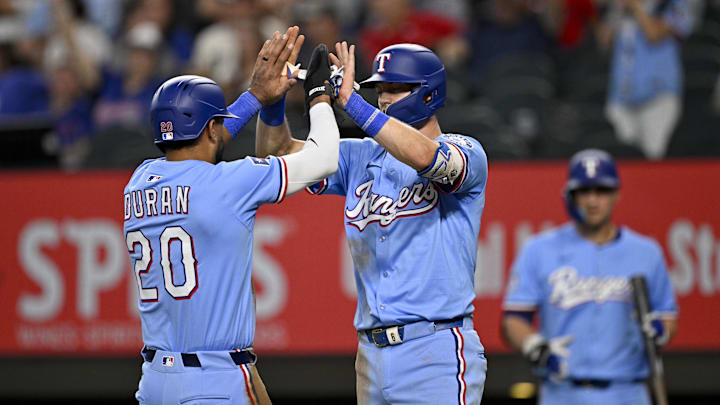 Aug 24, 2025; Arlington, Texas, USA; Texas Rangers second baseman Ezequiel Duran (20) and third baseman Josh Jung (6) celebrate after they score against the Cleveland Guardians during the fourth inning at Globe Life Field. Mandatory Credit: Jerome Miron-Imagn Images