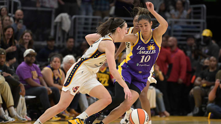 May 24, 2024; Los Angeles, California, USA;  Indiana Fever guard Caitlin Clark (22) is defended by Los Angeles Sparks guard Kia Nurse (10) in the second half at Crypto.com Arena. Mandatory Credit: Jayne Kamin-Oncea-Imagn Images