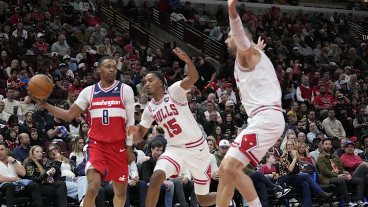 Apr 11, 2025; Chicago, Illinois, USA; Chicago Bulls forward Julian Phillips (15) defends Washington Wizards guard Bub Carrington (8) during the second half at United Center. Mandatory Credit: David Banks-Imagn Images