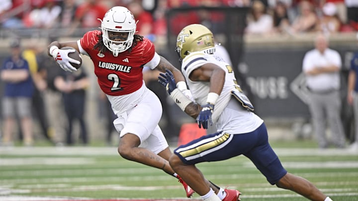 Sep 21, 2024; Louisville, Kentucky, USA;  Louisville Cardinals wide receiver Jadon Thompson (2) runs the ball against Georgia Tech Yellow Jackets defensive back Ahmari Harvey (3) during the second half at L&N Federal Credit Union Stadium. Louisville defeated Georgia Tech 31-19. Mandatory Credit: Jamie Rhodes-Imagn Images