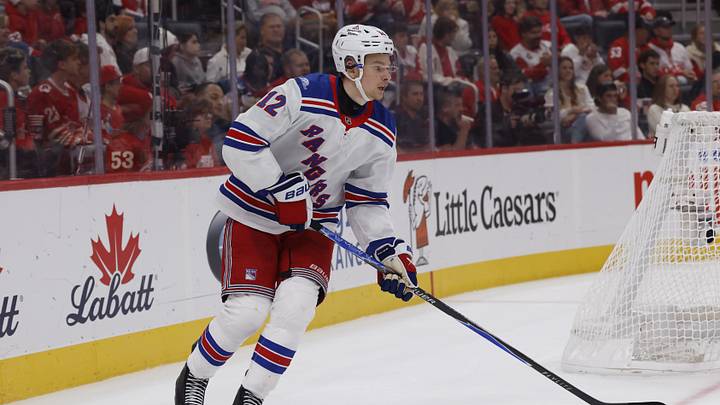 Oct 2, 2026; Detroit, Michigan, USA;  New York Rangers defense Alberts Smits (12) plays the puck during the third period against the Detroit Red Wings at Little Caesars Arena.  Mandatory Credit: Rick Osentoski-Imagn Images