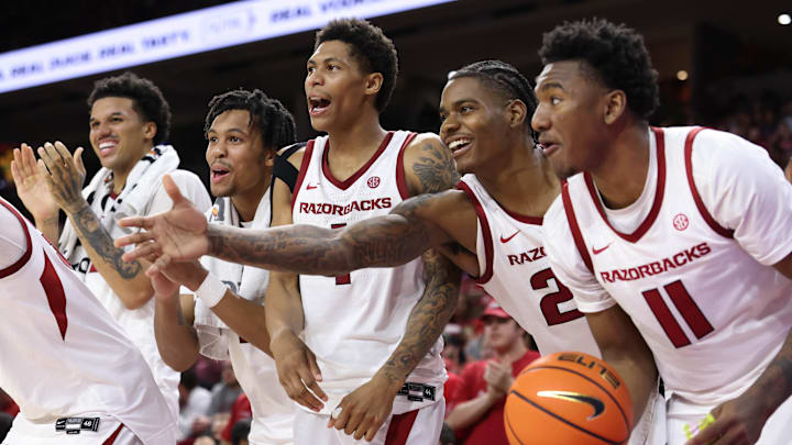 Nov 21, 2025; Fayetteville, Arkansas, USA; Arkansas Razorbacks forward Malique Ewin (12) guards D.J. wagner (21) Meleek Thomas (1) forward Nick Pringle (23) and wing Karter Knox (11) celebrate after a score in the second half against the Jackson State Tigers at Bud Walton Arena. Arkansas won 115-61. Mandatory Credit: Nelson Chenault-Imagn Images