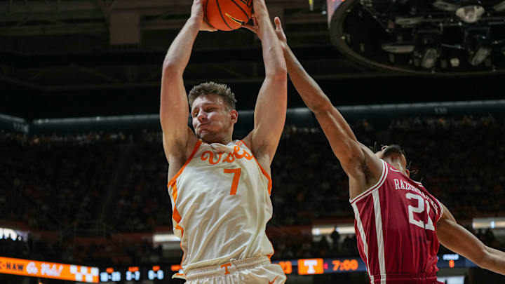 Tennessee forward Igor Miličić Jr (7) grabs the rebound from Arkansas guard D.J. Wagner (21) during a college basketball game between Tennessee and Arkansas held at Thompson-Boling Arena at Food City Center in Knoxville, Tenn., on Saturday, January 4, 2025.