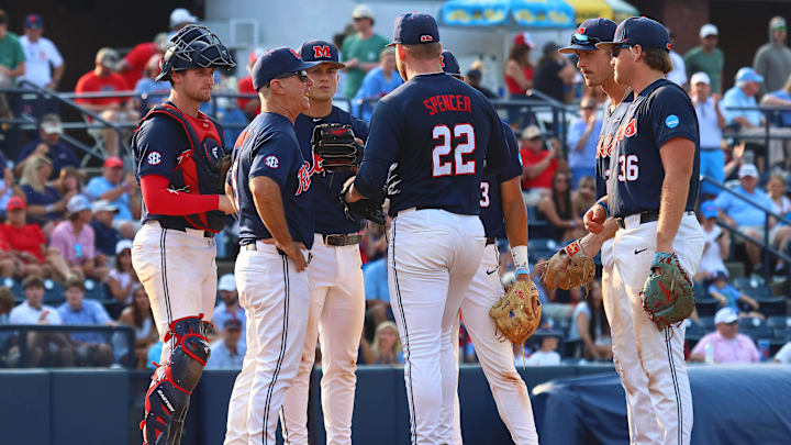 Jun 1, 2025; Oxford, MS, USA; Mississippi Rebels head coach Mike Bianco (left) makes a pitching change to pitcher Connor Spencer (22) during the ninth inning against the Georgia Tech Yellowjackets. Mandatory Credit: Petre Thomas-Imagn Images