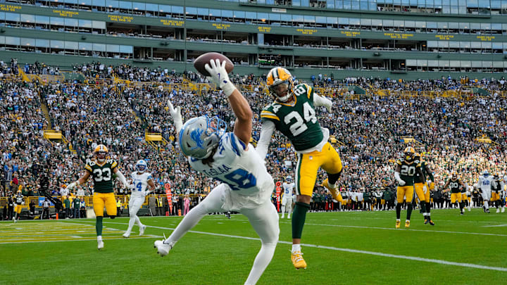 Sep 7, 2025; Green Bay, Wisconsin, USA; Detroit Lions wide receiver Isaac TeSlaa (18) makes a catch for a touchdown against Green Bay Packers cornerback Carrington Valentine (24) during the fourth quarter at Lambeau Field. The play was originally ruled an incomplete pass but the call was overturned. Mandatory Credit: Jeff Hanisch-Imagn Images