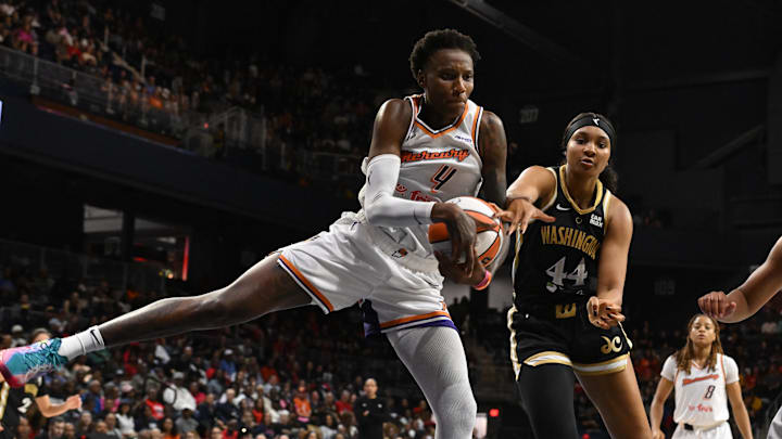 Sep 4, 2025; Washington, District of Columbia, USA;  Phoenix Mercury forward Natasha Mack (4) grabs a rebound in front of Washington Mystics forward Kiki Iriafen (44) during the fourth quarter at CareFirst Arena. Mandatory Credit: Rafael Suanes-Imagn Images