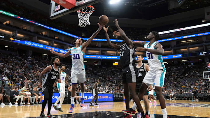 Charlotte Hornets guard Nick Smith Jr. (00) and San Antonio Spurs center Charles Bediako (27) at Golden 1 Center. Charlotte Hornets guard Nick Smith Jr. (00) and San Antonio Spurs center Charles Bediako (27) at Golden 1 Center.