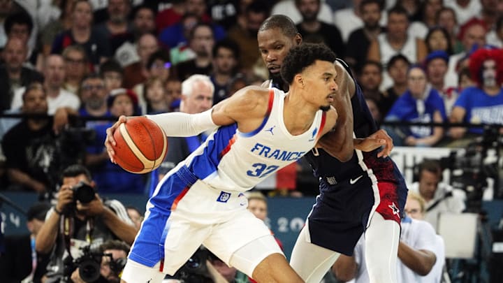 Aug 10, 2024; Paris, France; France power forward Victor Wembanyama (32) controls the ball against United States guard Kevin Durant (7) in the second half in the men's basketball gold medal game during the Paris 2024 Olympic Summer Games at Accor Arena. Mandatory Credit: Rob Schumacher-Imagn Images