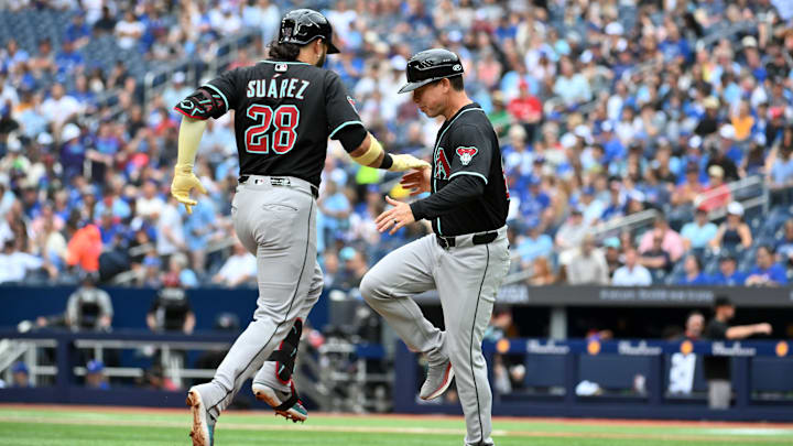 Jun 19, 2025; Toronto, Ontario, CAN;   Arizona Diamondbacks third baseman Eugenio Suarez (28) celebrates with third base coach Shaun Larkin after hitting a two run home run against the Toronto Blue Jays in the second inning at Rogers Centre. Mandatory Credit: Dan Hamilton-Imagn Images