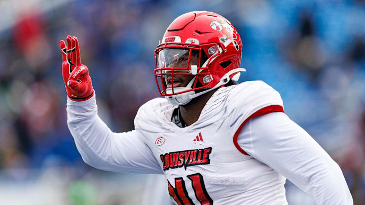 Nov 30, 2024; Lexington, Kentucky, USA; Louisville Cardinals defensive lineman Ramon Puryear (41) celebrates after intercepting a pass and scoring a touchdown during the third quarter against the Kentucky Wildcats at Kroger Field. Nov 30, 2024; Lexington, Kentucky, USA; Louisville Cardinals defensive lineman Ramon Puryear (41) celebrates after intercepting a pass and scoring a touchdown during the third quarter against the Kentucky Wildcats at Kroger Field.