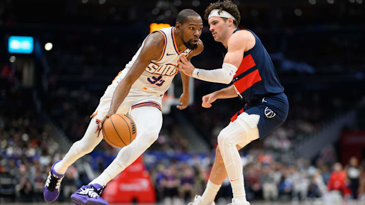Jan 16, 2025; Washington, District of Columbia, USA; Phoenix Suns forward Kevin Durant (35) handles the ball against Washington Wizards forward Corey Kispert (24) during the third quarter at Capital One Arena. Mandatory Credit: Reggie Hildred-Imagn Images