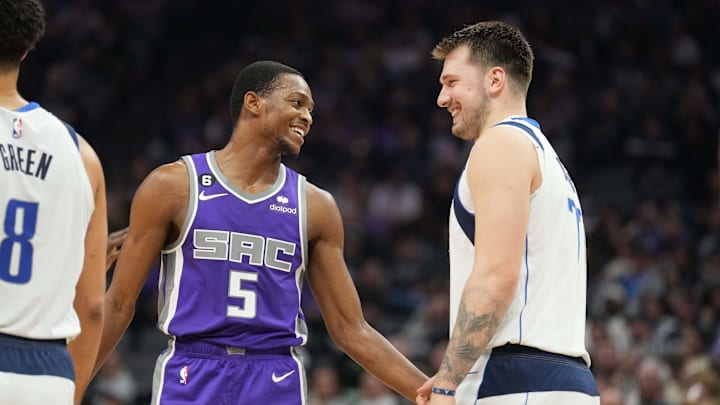 Feb 11, 2023; Sacramento, California, USA; Sacramento Kings guard De'Aaron Fox (5) and Dallas Mavericks guard Luka Doncic (77) talk during the second quarter at Golden 1 Center. Mandatory Credit: Darren Yamashita-Imagn Images