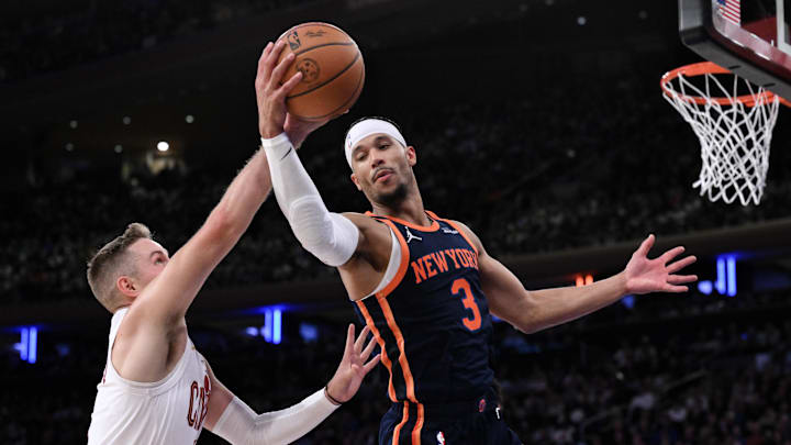 Oct 28, 2024; New York, New York, USA; New York Knicks guard Josh Hart (3) grabs a rebound against Cleveland Cavaliers guard Sam Merrill (5) during the second half at Madison Square Garden. Mandatory Credit: John Jones-Imagn Images