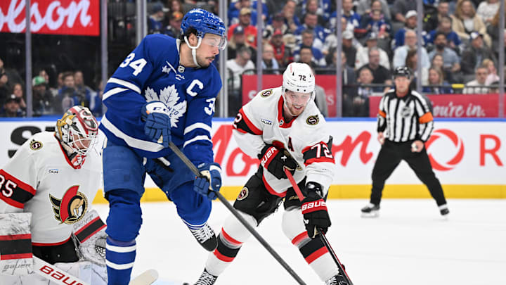 Mar 15, 2025; Toronto, Ontario, CAN;  Toronto Maple Leafs forward Auston Matthews (34) deflects the puck as Ottawa Senators defenseman Thomas Chabot (72) and goalie Linus Ullmark (35) defend in the first period at Scotiabank Arena. Mandatory Credit: Dan Hamilton-Imagn Images