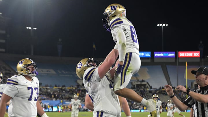 Huskies wide receiver Dezmen Roebuck (81) gets lifted up by  Geirean Hatchett (56) after scoring a touchdown at UCLA.