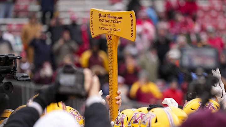 Nov 29, 2024; Madison, Wisconsin, USA;  The Minnesota Golden Gophers hold the Paul Bunyan Football Trophy following the game against the Wisconsin Badgers at Camp Randall Stadium. Mandatory Credit: Jeff Hanisch-Imagn Images