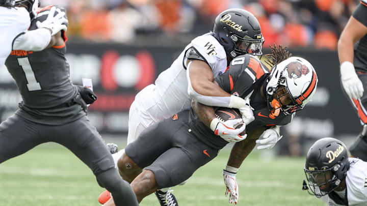 Oct 11, 2025; Corvallis, Oregon, USA; Oregon State Beavers running back Anthony Hankerson (0) is tacked after a run by Wake Forest Demon Deacons linebacker Langston Hardy (11) during the second half at Reser Stadium. Mandatory Credit: Craig Strobeck-Imagn Images Oct 11, 2025; Corvallis, Oregon, USA; Oregon State Beavers running back Anthony Hankerson (0) is tacked after a run by Wake Forest Demon Deacons linebacker Langston Hardy (11) during the second half at Reser Stadium. Mandatory Credit: Craig Strobeck-Imagn Images