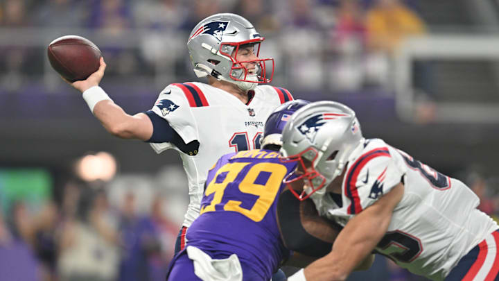 Nov 24, 2022; Minneapolis, Minnesota, USA; New England Patriots quarterback Mac Jones (10) throws a pass as Minnesota Vikings linebacker Danielle Hunter (99) rushes in during the first quarter at U.S. Bank Stadium. Mandatory Credit: Jeffrey Becker-Imagn Images