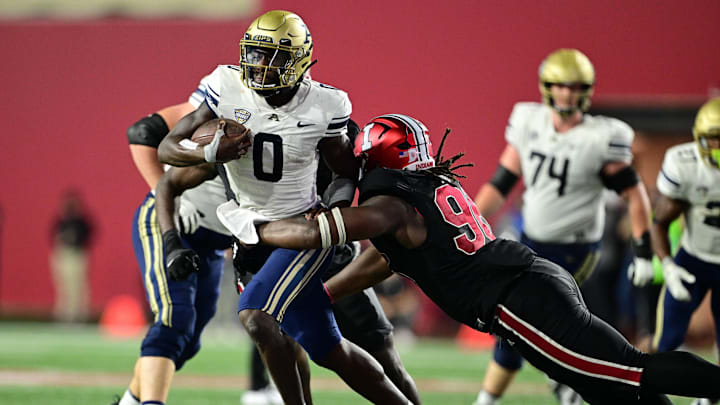 Sep 23, 2023; Bloomington, Indiana, USA; Akron Zips quarterback DJ Irons (0) is tackled by Indiana