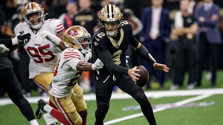 Sep 14, 2025; New Orleans, Louisiana, USA; New Orleans Saints quarterback Spencer Rattler (2) runs from San Francisco 49ers cornerback Upton Stout (20) during the second half at Caesars Superdome. Mandatory Credit: Matthew Hinton-Imagn Images
