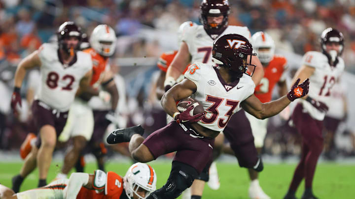 Sep 27, 2024; Miami Gardens, Florida, USA; Virginia Tech Hokies running back Bhayshul Tuten (33) runs with the football against the Miami Hurricanes during the third quarter at Hard Rock Stadium. Mandatory Credit: Sam Navarro-Imagn Images