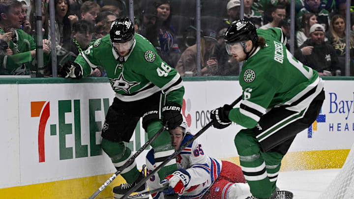 Dec 20, 2024; Dallas, Texas, USA; Dallas Stars defenseman Ilya Lyubushkin (46) and defenseman Lian Bichsel (6) and New York Rangers left wing Brett Berard (65) battle for control of the puck during the first period at the American Airlines Center. Mandatory Credit: Jerome Miron-Imagn Images Dec 20, 2024; Dallas, Texas, USA; Dallas Stars defenseman Ilya Lyubushkin (46) and defenseman Lian Bichsel (6) and New York Rangers left wing Brett Berard (65) battle for control of the puck during the first period at the American Airlines Center. Mandatory Credit: Jerome Miron-Imagn Images