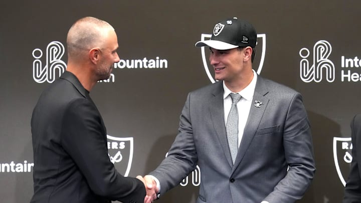 Apr 24, 2026; Henderson, NV, USA; Las Vegas Raiders quarterback Fernando Mendoza (right) shakes hands with general manager John Spytek at introductory press conference at Intermountain Health Performance Center after being selected as the No. 1 pick in the 2026 NFL Draft. Mandatory Credit: Kirby Lee-Imagn Images