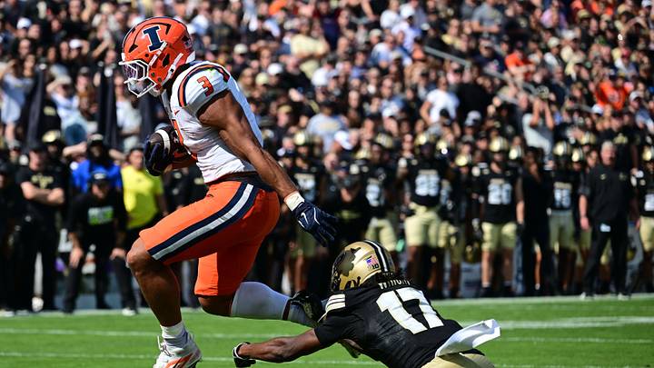 Oct 4, 2025; West Lafayette, Indiana, USA; Illinois Fighting Illini running back Kaden Feagin (3) jumps to avoid tackle by Purdue Boilermakers defensive back Traveon Wright (17) during the second quarter at Ross-Ade Stadium. Mandatory Credit: Marc Lebryk-Imagn Images