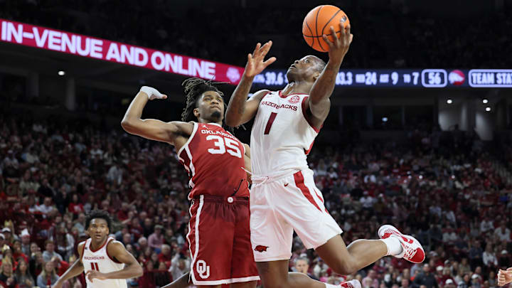 Jan 25, 2025; Fayetteville, Arkansas, USA; Arkansas Razorbacks guard Johnell Davis (1) shoots in the second half as Oklahoma Sooners forward Glenn Taylor Jr (35) defends at Bud Walton Arena. Oklahoma won 65-62. Mandatory Credit: Nelson Chenault-Imagn Images