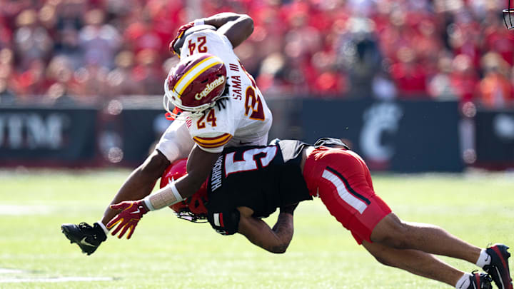 Cincinnati Bearcats safety Christian Harrison (5) tackles Iowa State Cyclones defensive back Quentin Taylor Jr. (24) in the fourth quarter of the NCAA football game between the Cincinnati Bearcats and Iowa State Cyclones at Nippert Stadium in Cincinnati on Oct. 4, 2025.