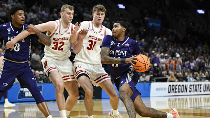 Mar 19, 2026; Portland, OR, USA; High Point Panthers forward Cam'ron Fletcher (11) dribs to the basket against Wisconsin Badgers forward Aleksas Bieliauskas (32) and forward Nolan Winter (31) during the first half of a first round game of the men's 2026 NCAA Tournament at Moda Center. Mandatory Credit: Troy Wayrynen-Imagn Images
