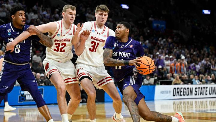 Mar 19, 2026; Portland, OR, USA; High Point Panthers forward Cam'ron Fletcher (11) dribs to the basket against Wisconsin Badgers forward Aleksas Bieliauskas (32) and forward Nolan Winter (31) during the first half of a first round game of the men's 2026 NCAA Tournament at Moda Center. Mandatory Credit: Troy Wayrynen-Imagn Images Mar 19, 2026; Portland, OR, USA; High Point Panthers forward Cam'ron Fletcher (11) dribs to the basket against Wisconsin Badgers forward Aleksas Bieliauskas (32) and forward Nolan Winter (31) during the first half of a first round game of the men's 2026 NCAA Tournament at Moda Center. Mandatory Credit: Troy Wayrynen-Imagn Images