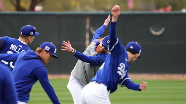 Feb 12, 2025; Glendale, AZ, USA; Los Angeles Dodgers pitcher Dustin May stretches with teammates during a Spring Training workout at Camelback Ranch. Mandatory Credit: Joe Camporeale-Imagn Images Feb 12, 2025; Glendale, AZ, USA; Los Angeles Dodgers pitcher Dustin May stretches with teammates during a Spring Training workout at Camelback Ranch. Mandatory Credit: Joe Camporeale-Imagn Images