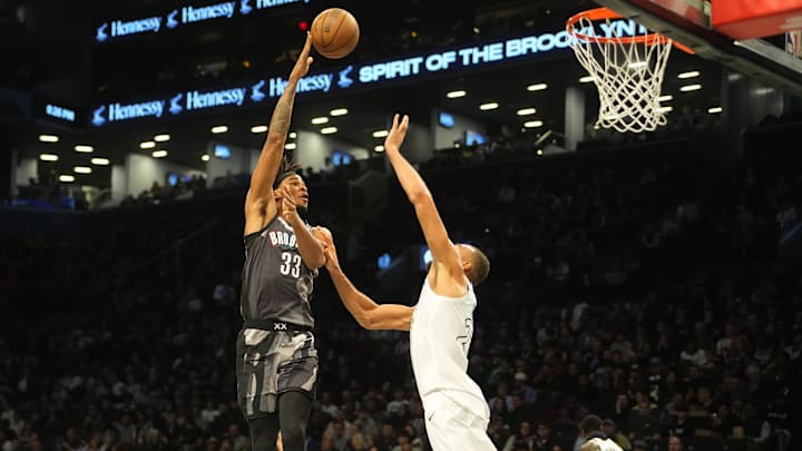 Apr 3, 2025; Brooklyn, New York, USA; Brooklyn Nets center Nic Claxton (33) shoots a hook shot over Minnesota Timberwolves center Rudy Gobert (27) during the first half at Barclays Center. Mandatory Credit: Gregory Fisher-Imagn Images
