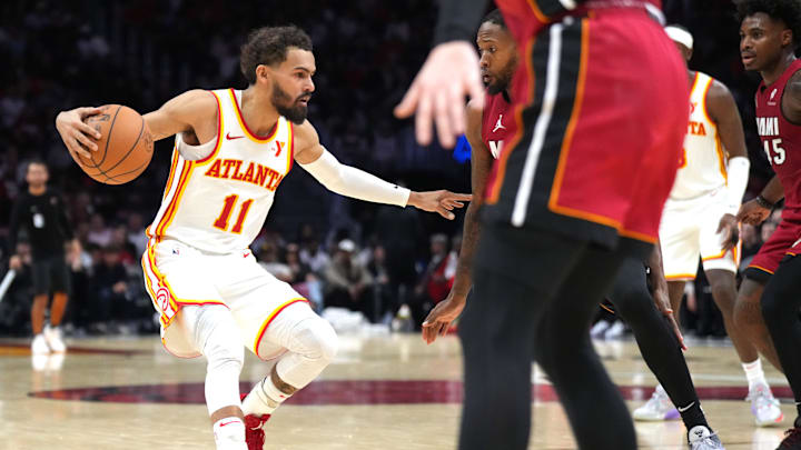 Feb 26, 2025; Miami, Florida, USA; Atlanta Hawks guard Trae Young (11) steps back as Miami Heat forward Haywood Highsmith (24) defends in the second half at Kaseya Center. Mandatory Credit: Jim Rassol-Imagn Images
