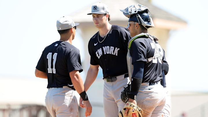 Mar 11, 2025; Bradenton, Florida, USA;  New York Yankees starting pitcher Cam Schlittler (76) talks with shortstop Anthony Volpe (11) and  catcher J.C. Escarra (79)  on the mound during the third inning against the Pittsburgh Pirates at LECOM Park. Mandatory Credit: Kim Klement Neitzel-Imagn Images