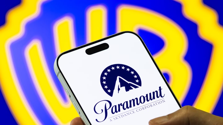Paramount Logo on Smartphone Against Warner Bros. Discovery Background
