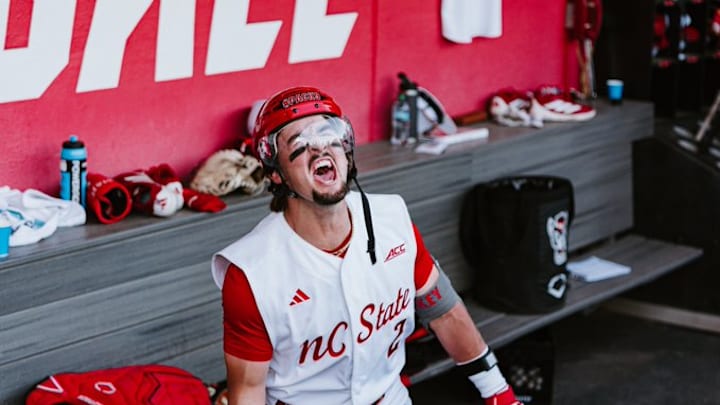 Shortstop Mikey Ryan wears a hockey helmet in the dugout to celebrate hitting a home run in NC State's 10-4 victory over Duke on Friday, April 10, 2026. 
