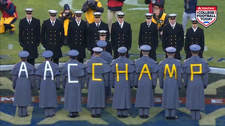 Army and Navy meet at midfield for “prisoner exchange” ahead of Army-Navy game.