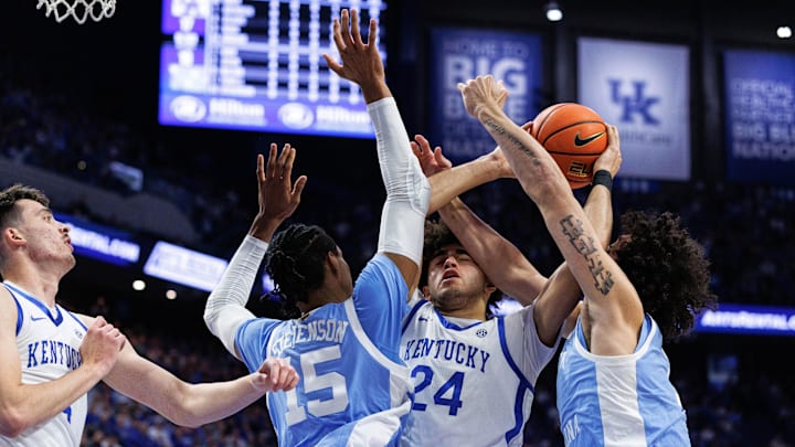 Dec 2, 2025; Lexington, Kentucky, USA; Kentucky Wildcats center Malachi Moreno (24) attempts to grab the rebound against North Carolina Tar Heels forwards Jarin Stevenson (15) and Zayden High (1) during the first half at Rupp Arena at Central Bank Center. Mandatory Credit: Jordan Prather-Imagn Images